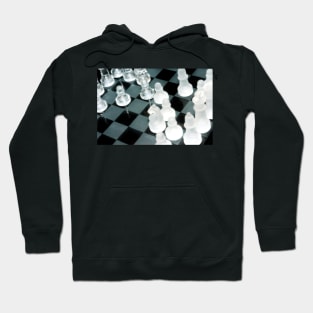 The next move - Glass chess pieces on a chess board Hoodie